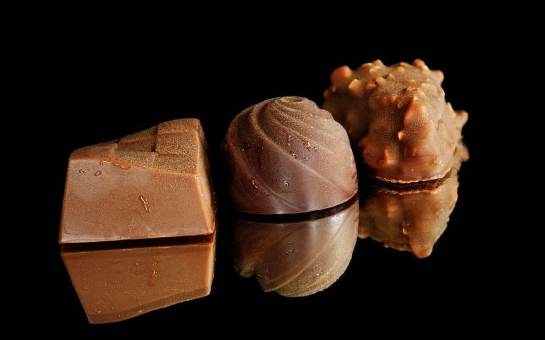 A box of classic chocolate bonbons tied with ribbon